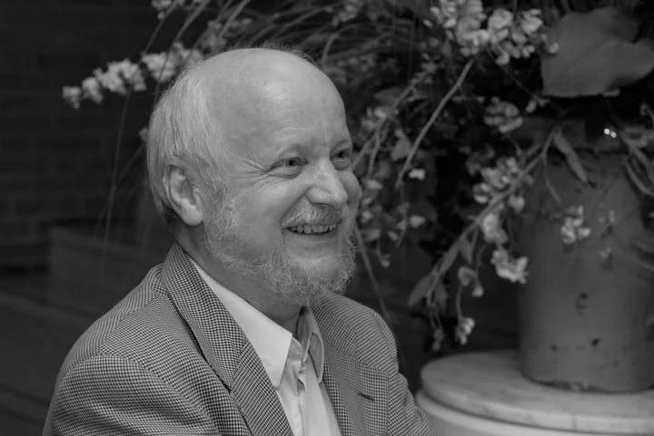 Ein freundlich aussehender älterer Mann mit Bart (Günter Pichler) lächelt. Im Hintergrund sind Blumen zu sehen, die Atmosphäre wirkt warm.