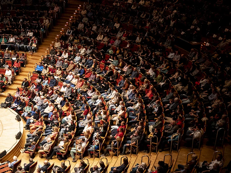Kölner Philharmonie: A packed concert hall with a large audience seated in a semi-circular auditorium, ready for an event.