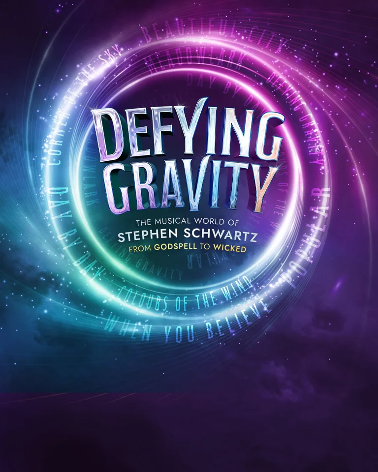 A logo with the text »Defying Gravity« in vibrant colors on a dark, cosmic background. Radiant circles frame the text.